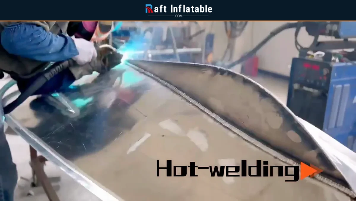 Welder joining an aluminum rigid inflatable boat hull section