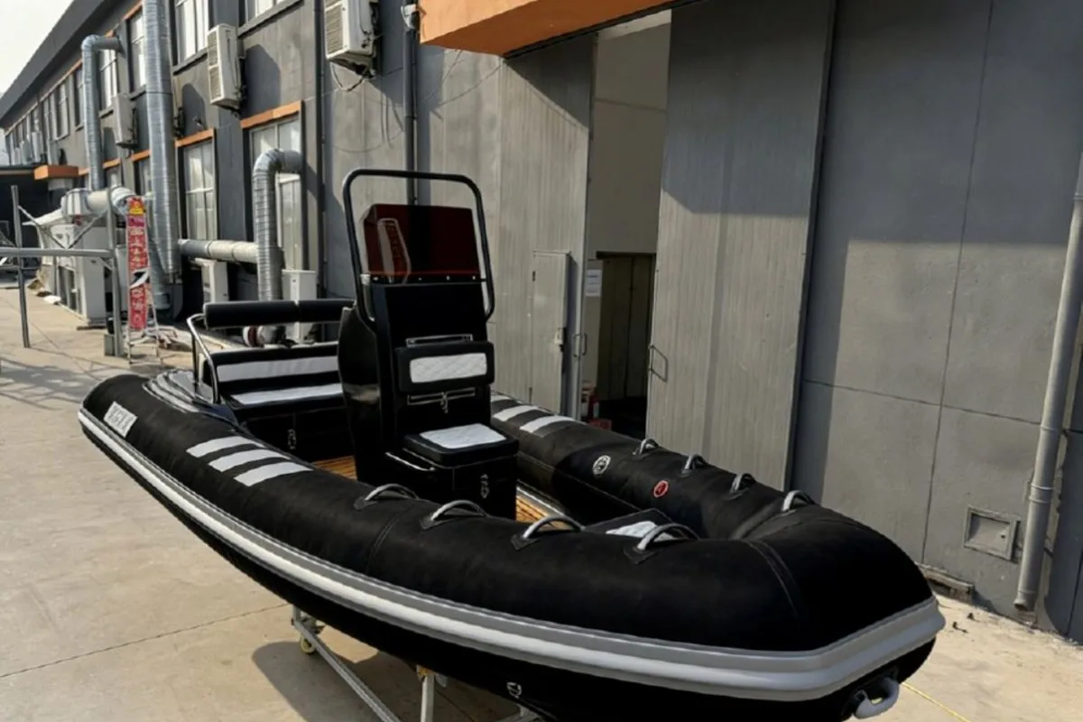 SP580-FG fiberglass RIB boat black three-quarter view outside the supplier workshop